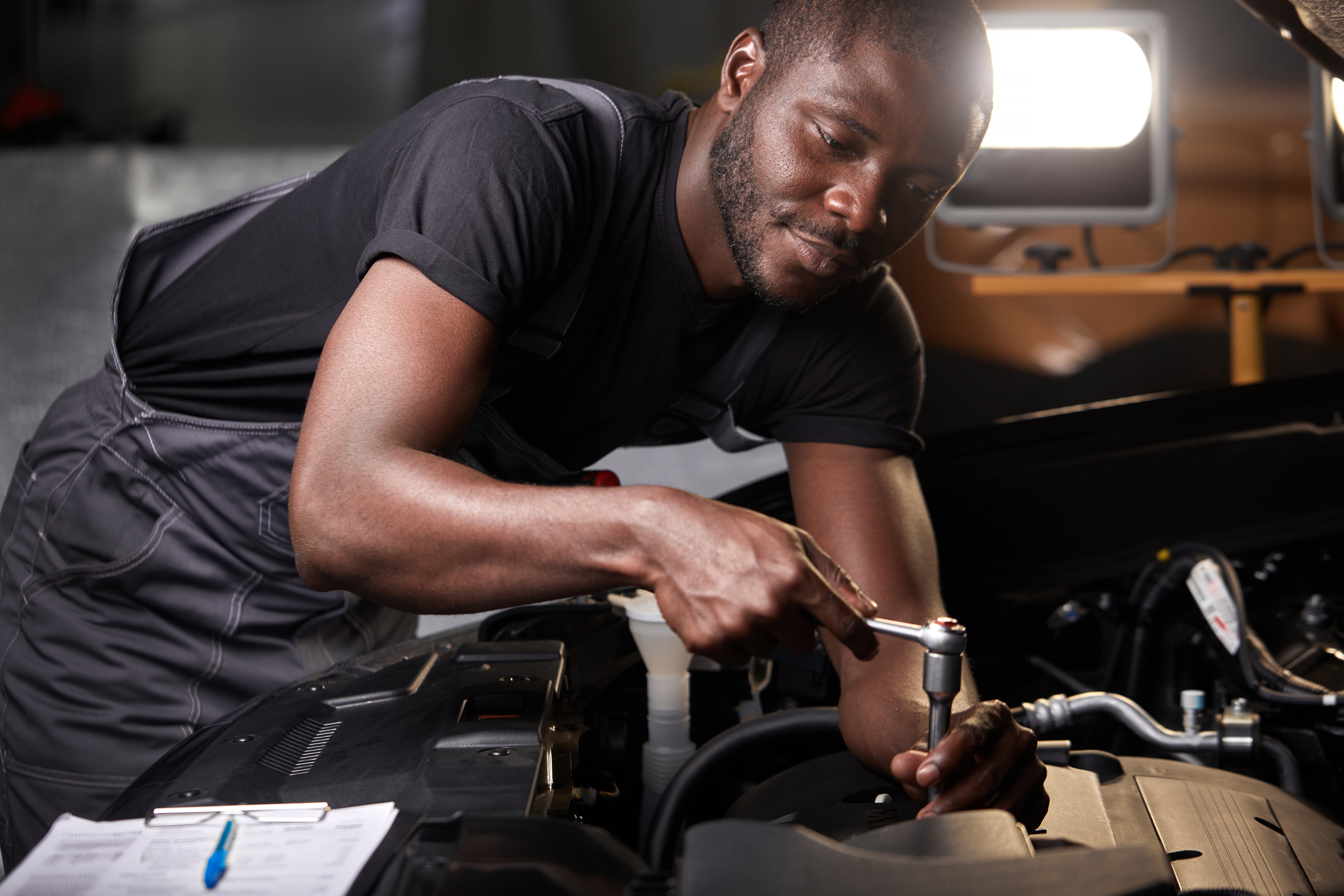 mechanic servicing car engine